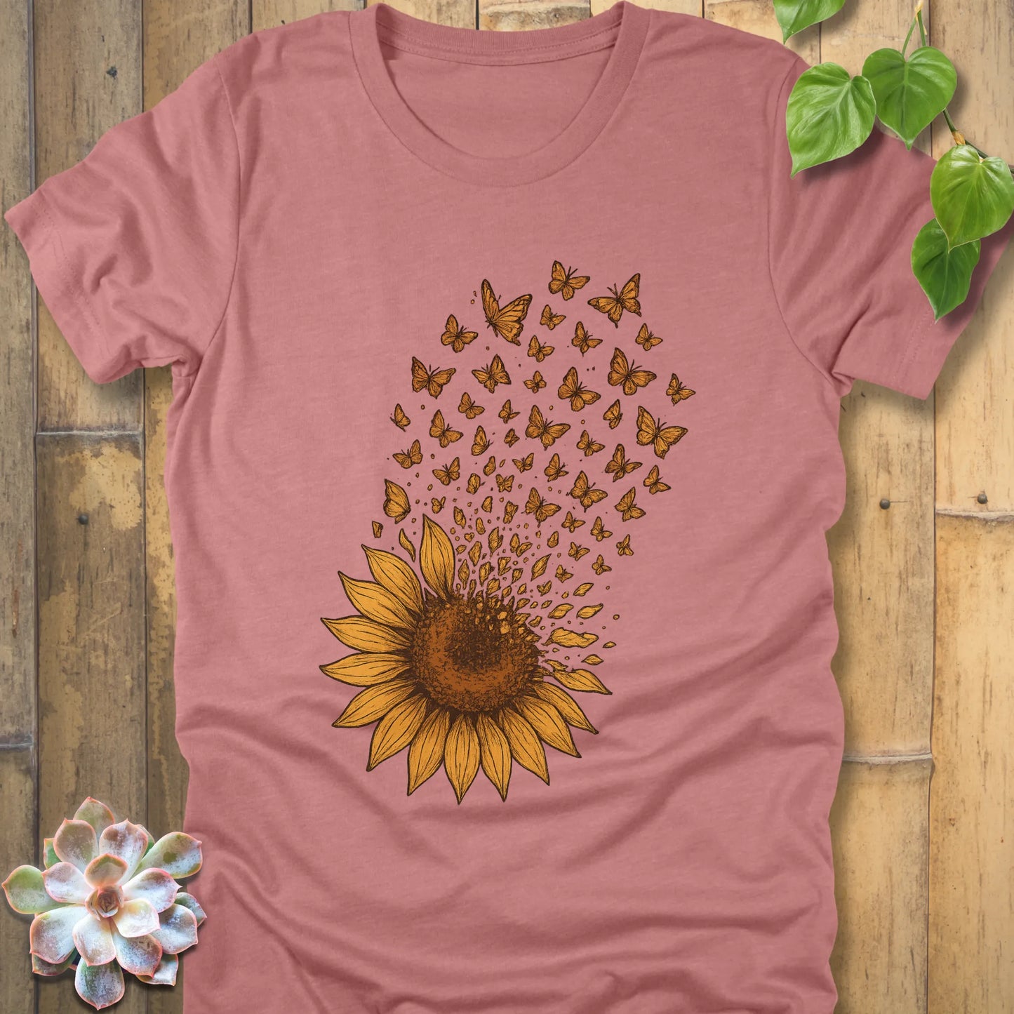 Heather Mauve t-shirt with a sunflower design where the petals turn into butterflies floating away