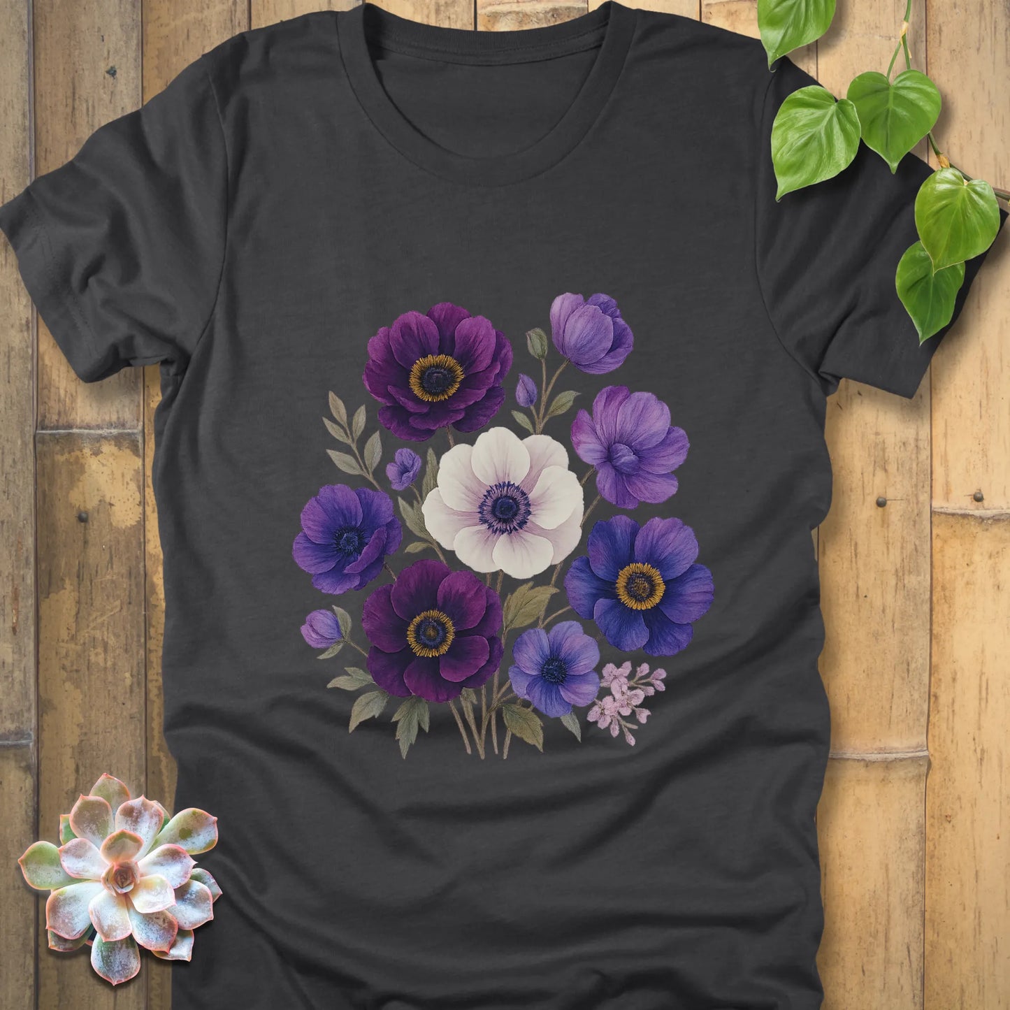 Dark Grey Heather t-shirt with a striking bouquet of purple, violet, blue, and white blossoms accented by soft green leaves