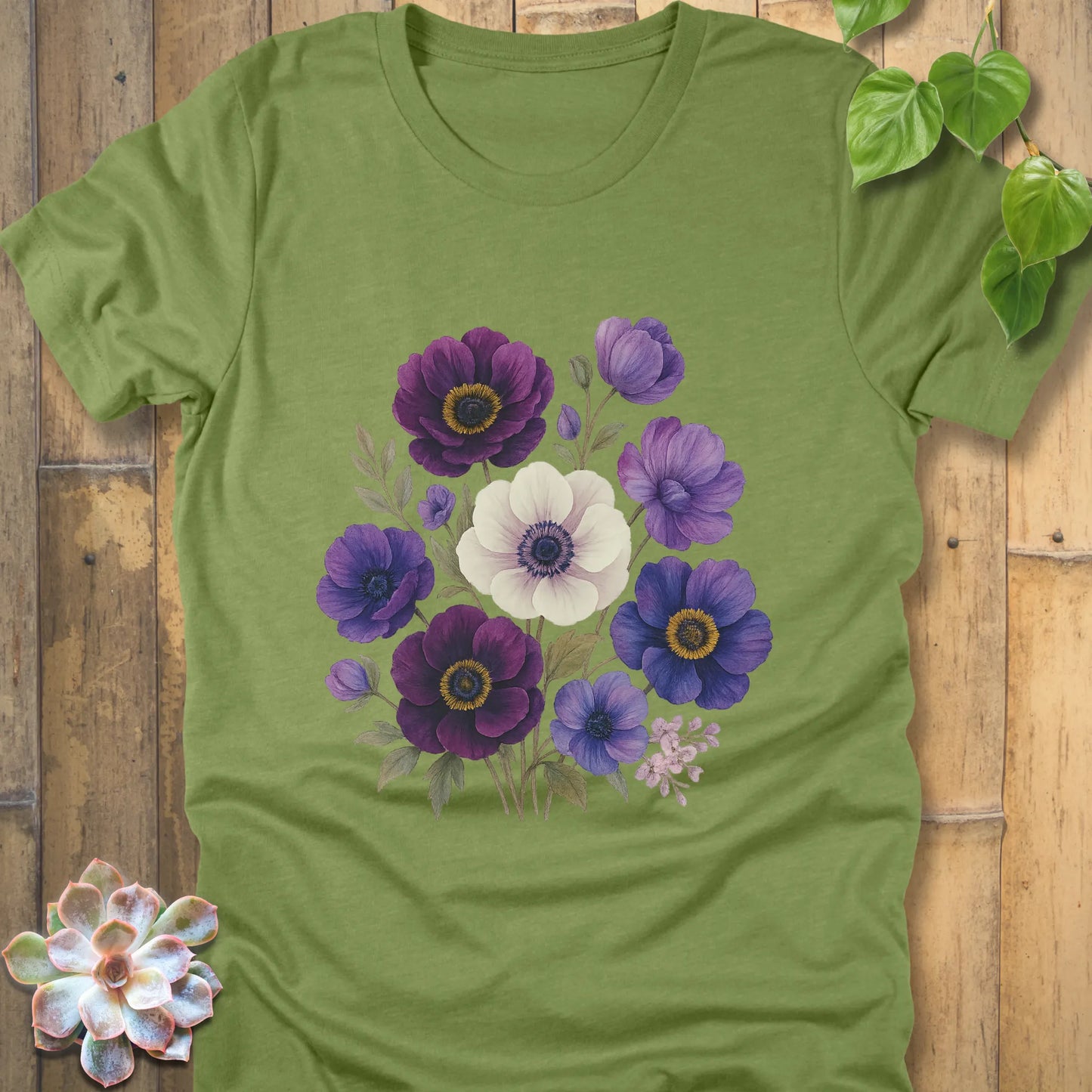 Heather Green t-shirt decorated with a bouquet of purple, blue, and white flowers accented with green leaves