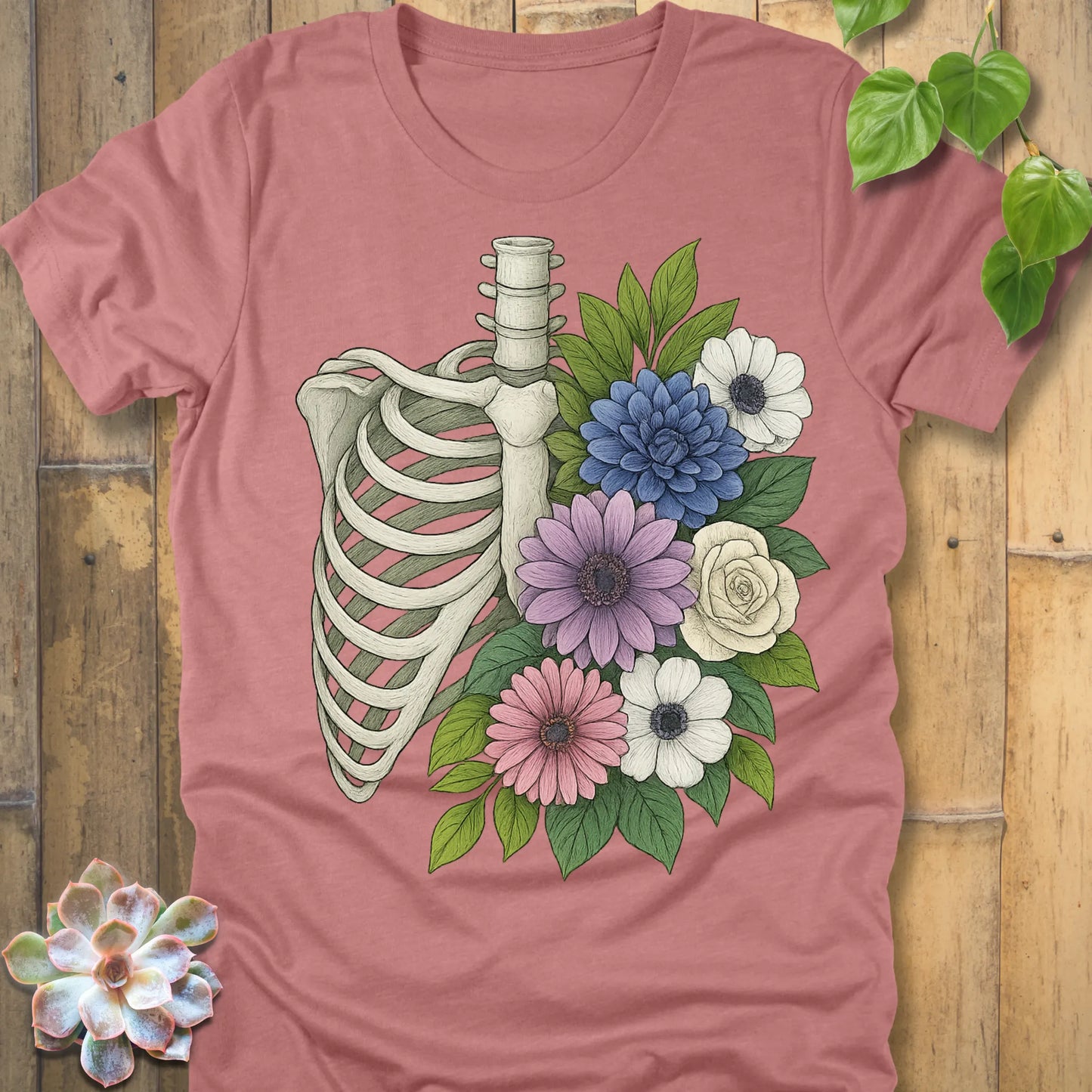 Floral Bones T-shirt in Heather Mauve – artistic ribcage with floral design on soft Bella+Canvas unisex shirt.