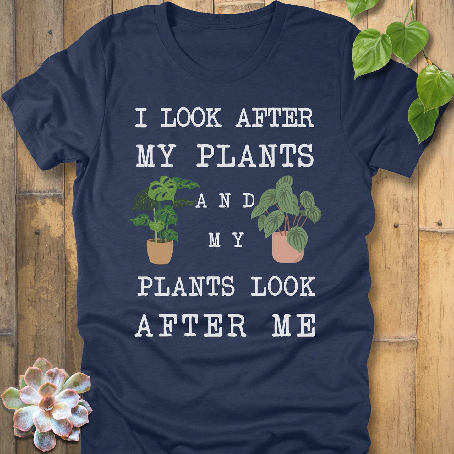 Heather Navy Bella Canvas 3001 t-shirt with white writing saying I look after my plants and my plants look after me. I have two house plants on each side.