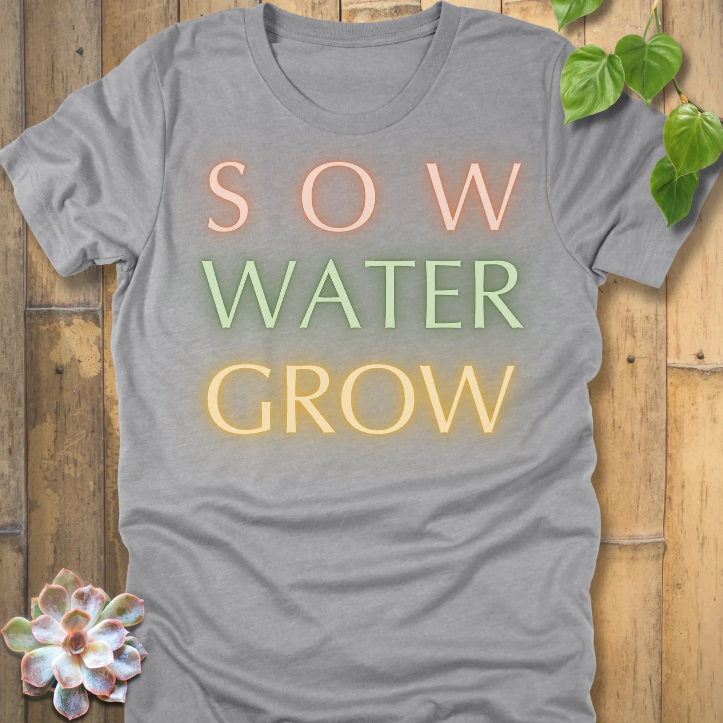 Athletic Heather t-shirt featuring the design Grow Dammit printed in bold letters, funny gardening shirt.