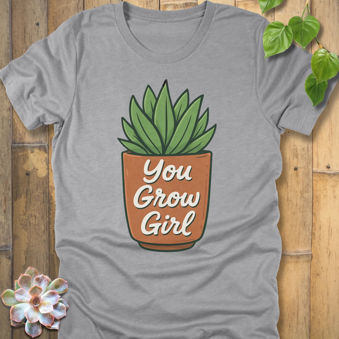 Athletic Heather t-shirt featuring the design Grow Girl printed in bold letters and plant in the pot, casual plant lover shirt.