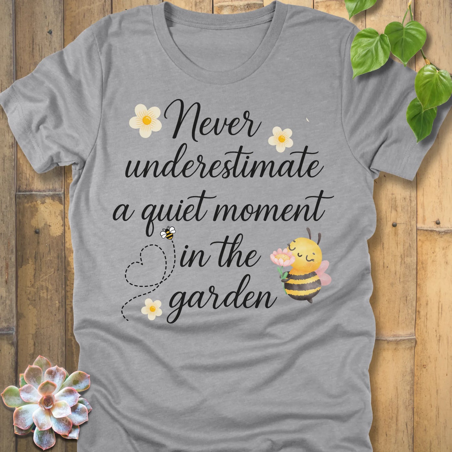 Athletic Heather t-shirt featuring the design Never Underestimate printed in black letters, empowering quote shirt.