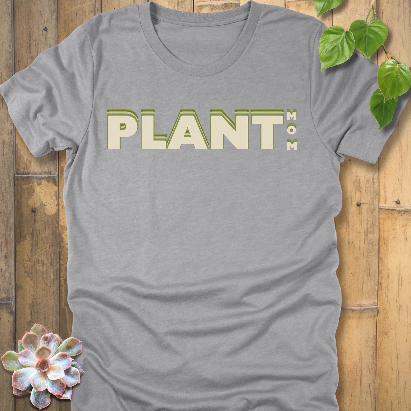 Athletic Heather t-shirt featuring the design Plant Mom printed in bold green letters