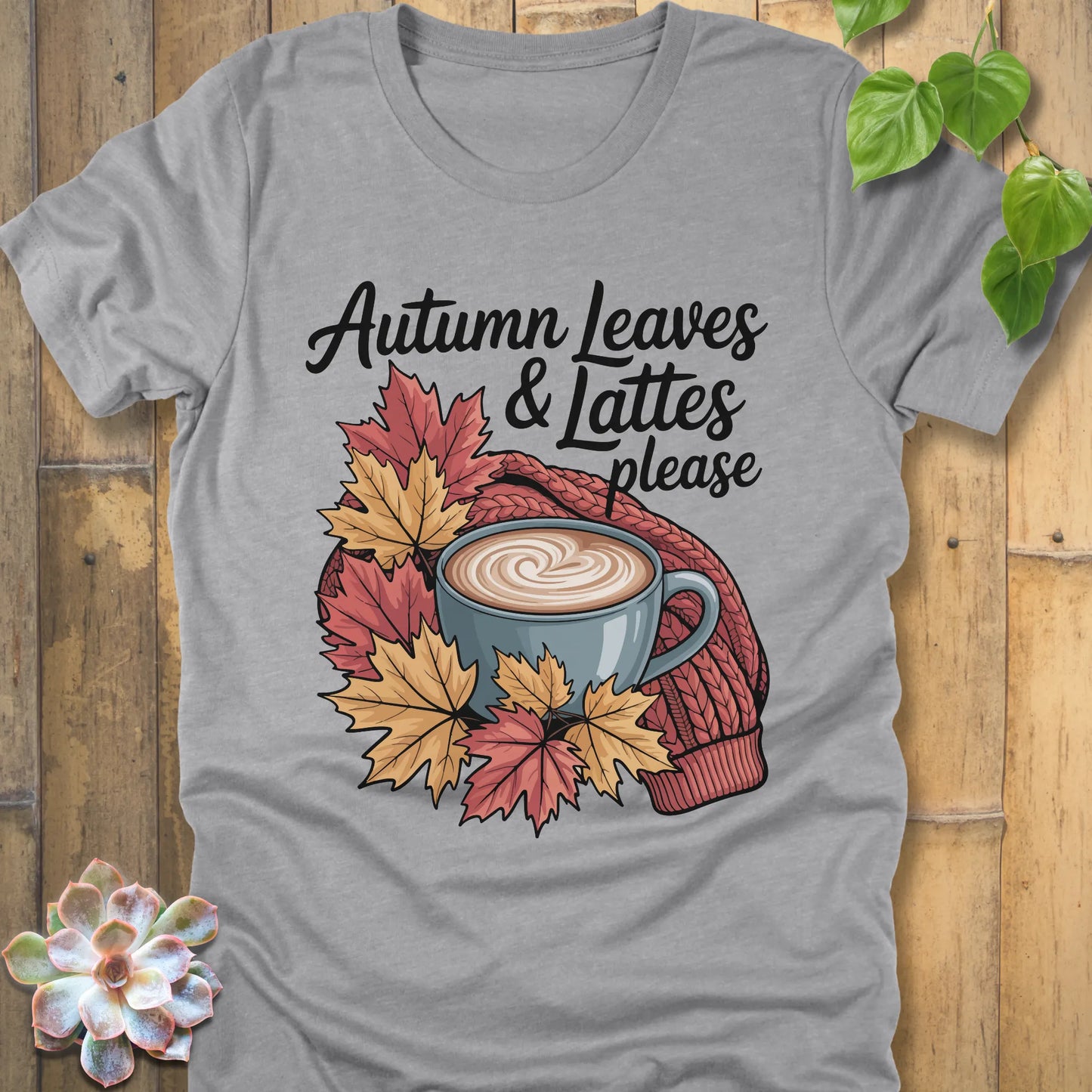Athletic grey t-shirt featuring the design Autumn Leaves & Lattes printed in black letters with a mug of coffee and leaves