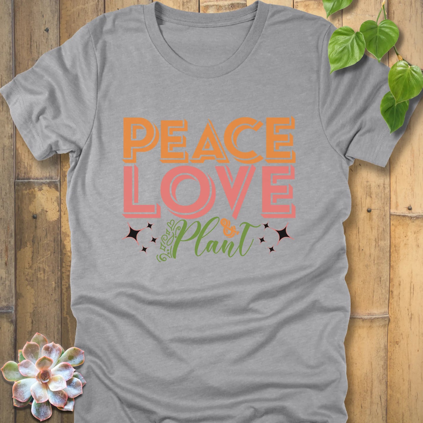 Athletic grey t-shirt featuring the design Peace Love Plant printed in bold letters, ethical everyday wear shirt