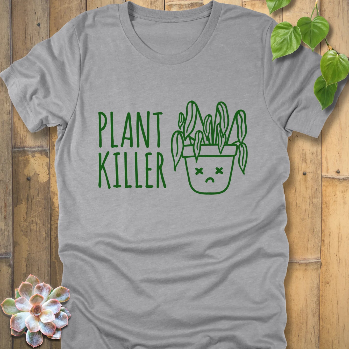 Athletic grey t-shirt featuring the design Plant Killer printed in green letters with a plant in an emoji pot