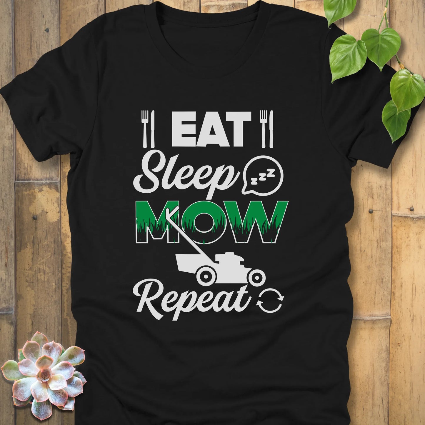 Black t-shirt featuring the design Eat, Sleep, Mow, Repeat printed with a lawn mower