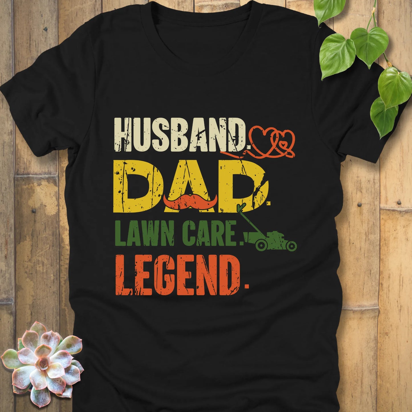 Black t-shirt featuring the design "Husband, Dad lawn care legend" printed in bold letters