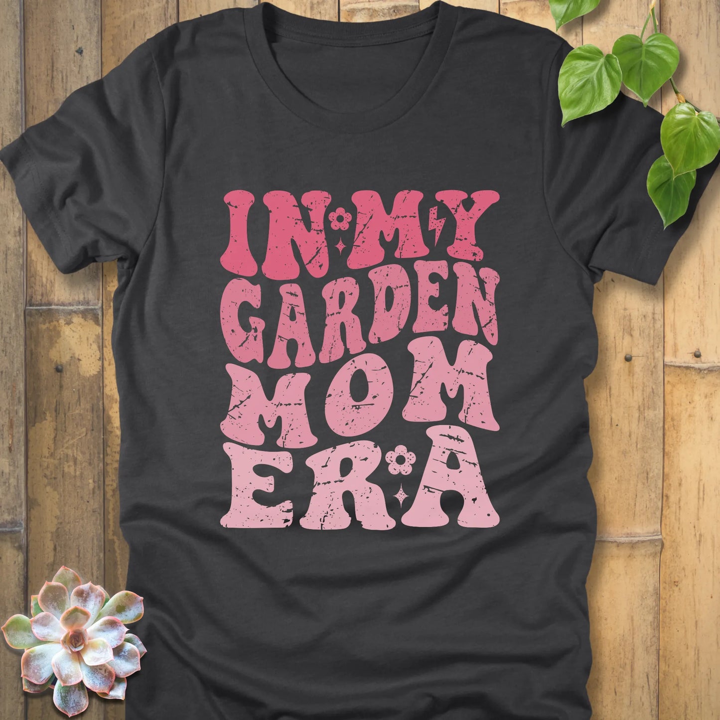 Dark Grey Heather t-shirt featuring the design In My Garden Mom Era printed in bold pink letters, chic outdoor gardening wear.