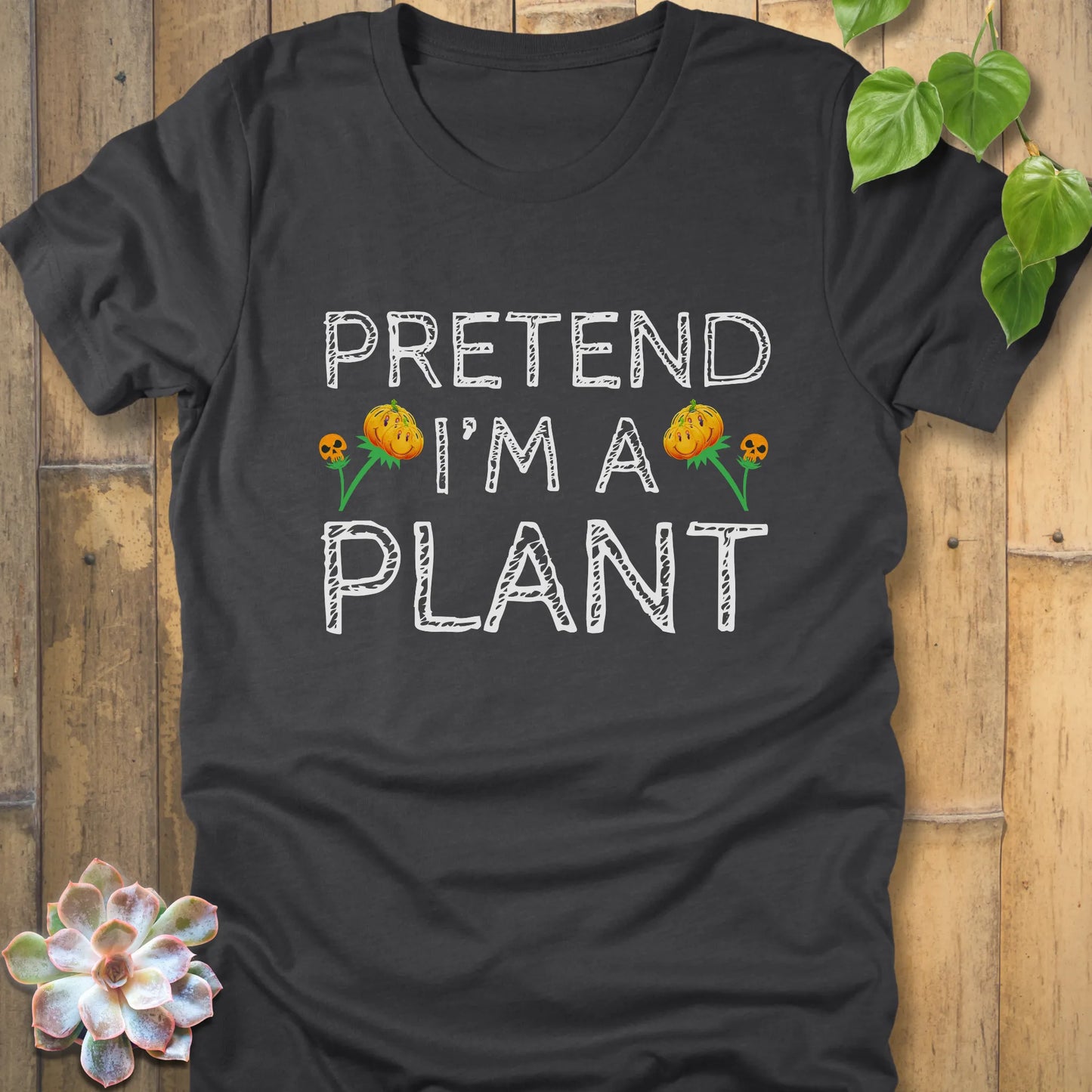 Dark Grey Heather t-shirt featuring the design Pretend I'm A Plant printed in bold white letters with plants