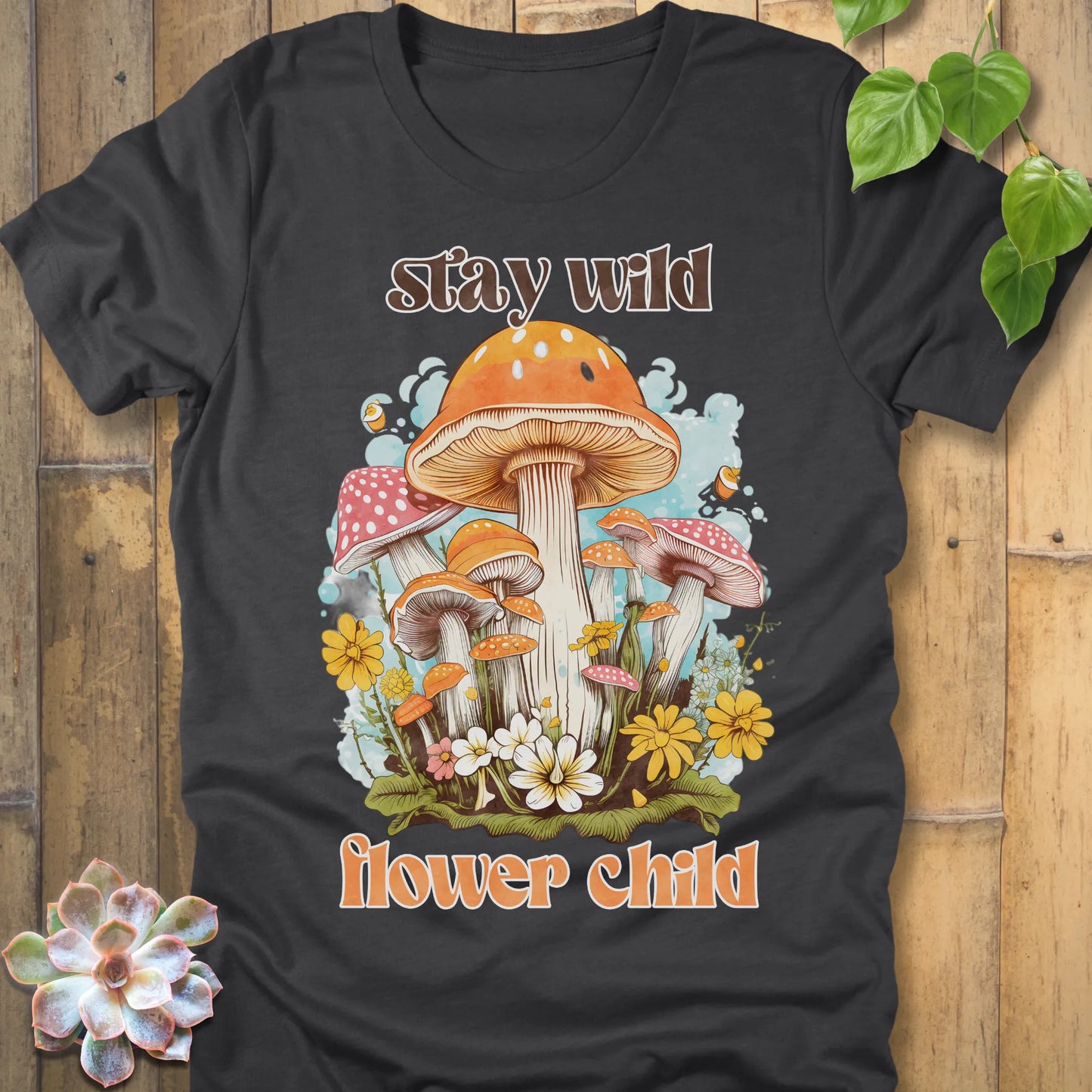 Dark Grey Heather t-shirt featuring the design Stay Wild Flower printed in bold letters, floral graphic tee.