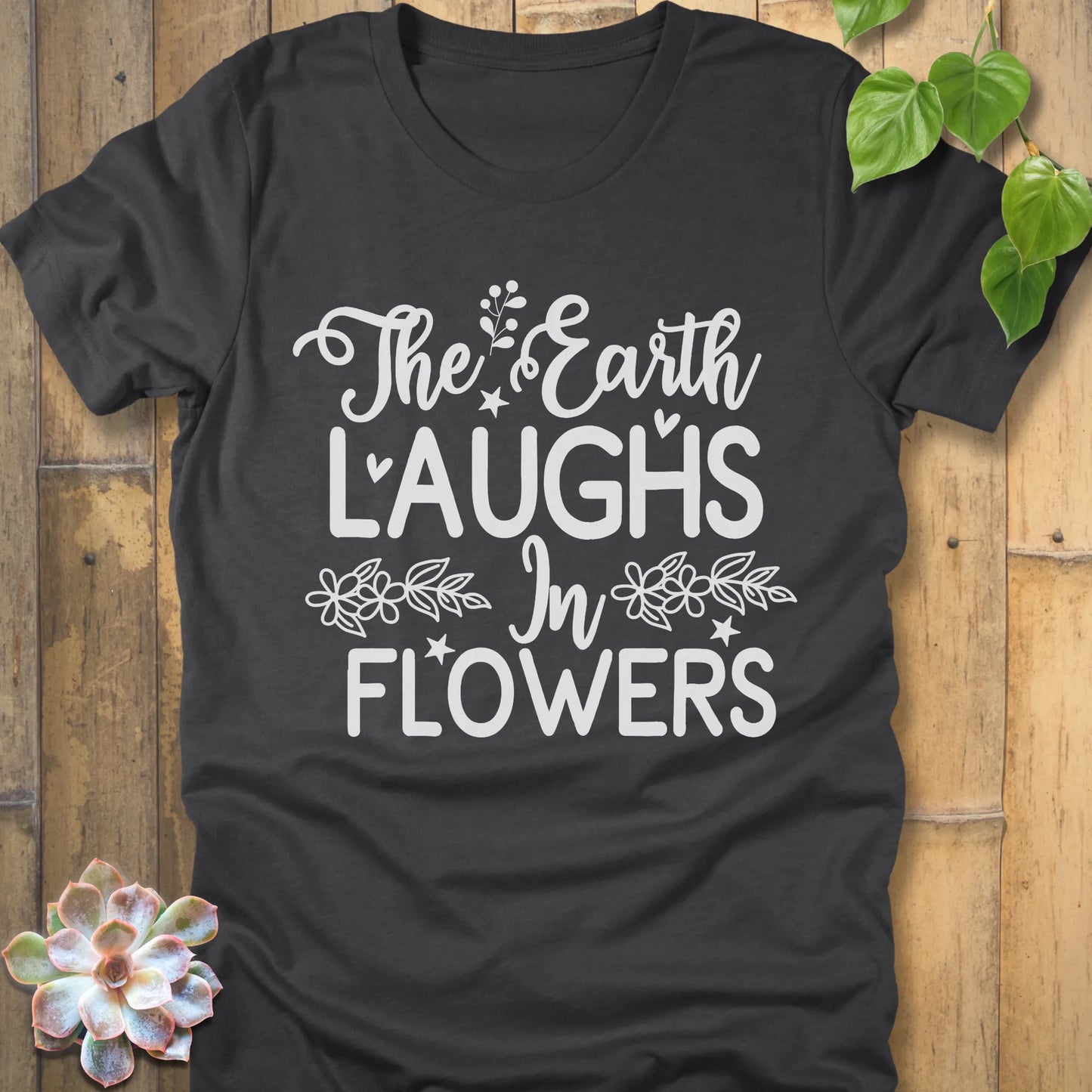 Dark Grey Heather t-shirt featuring the design The earth laughs in flowers printed in bold white letters