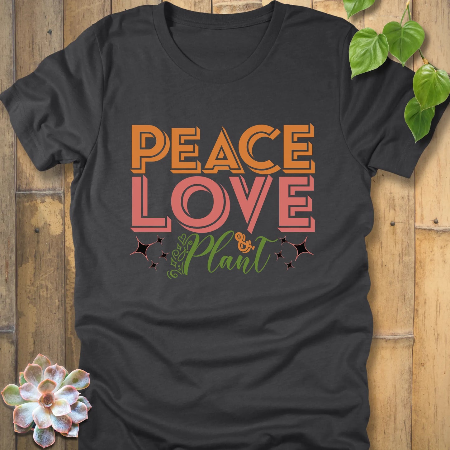 Dark grey heather t-shirt featuring the design Peace Love Plant printed in bold letters, sustainable botanical graphic tee