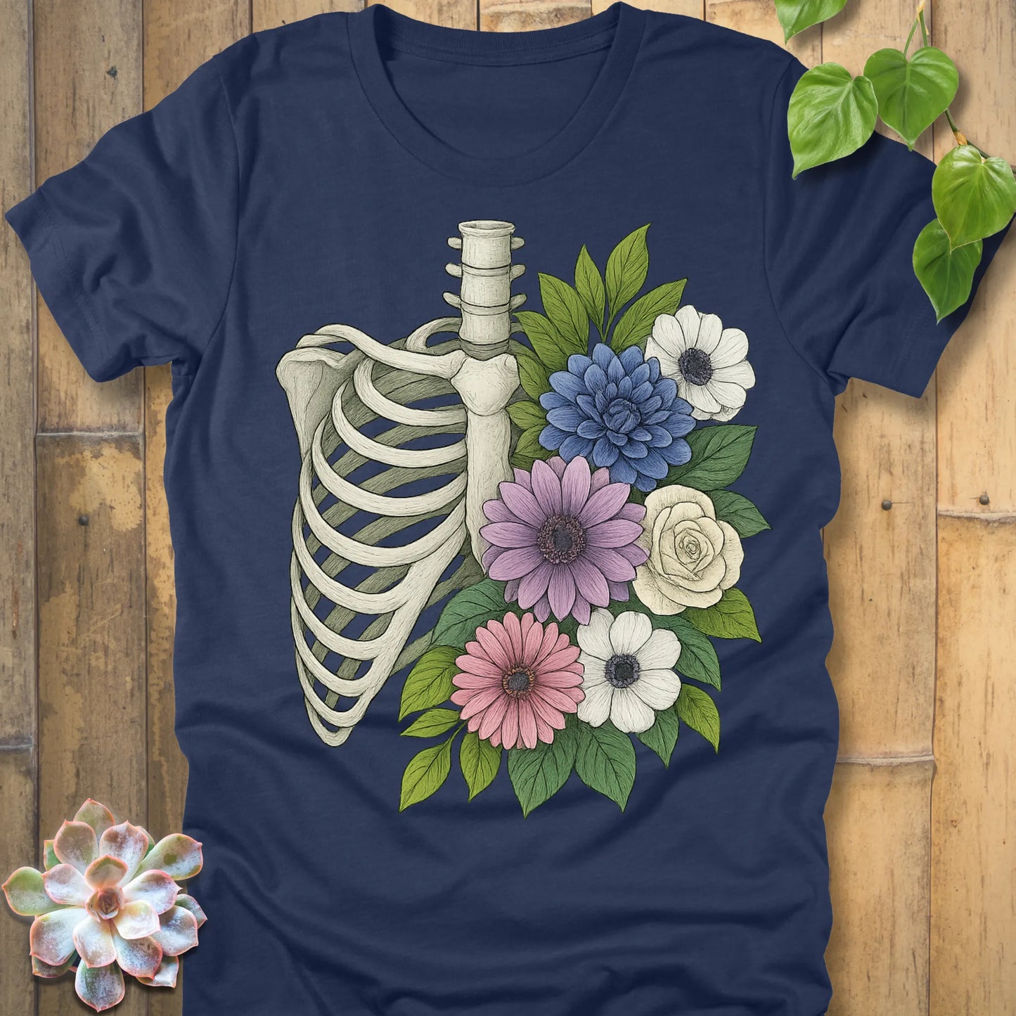 Floral Bones T-shirt in Heather Navy – ribcage with colorful flowers graphic, printed on Bella+Canvas soft cotton tee.