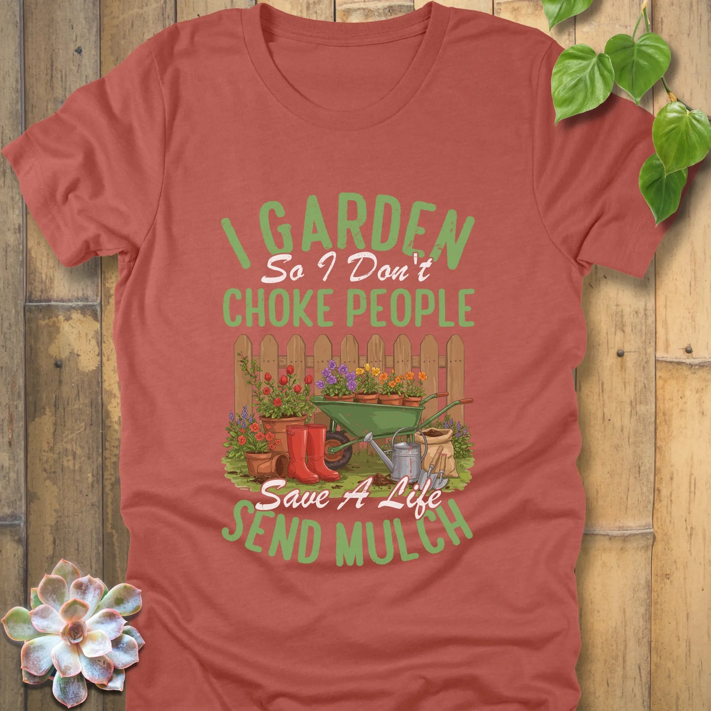 Heather Clay t-shirt featuring the design 'I garden so I don't choke people, save a life send mulch' with plants and tools graphic