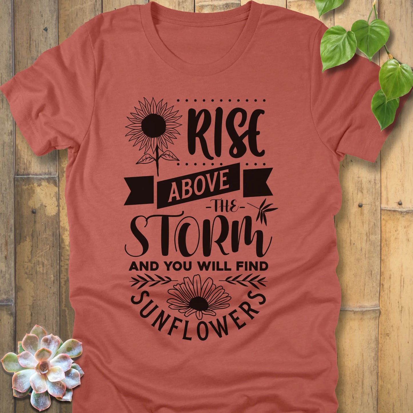 Heather Clay t-shirt featuring the design Rise above the storm and you will find sunflowers printed in white letters