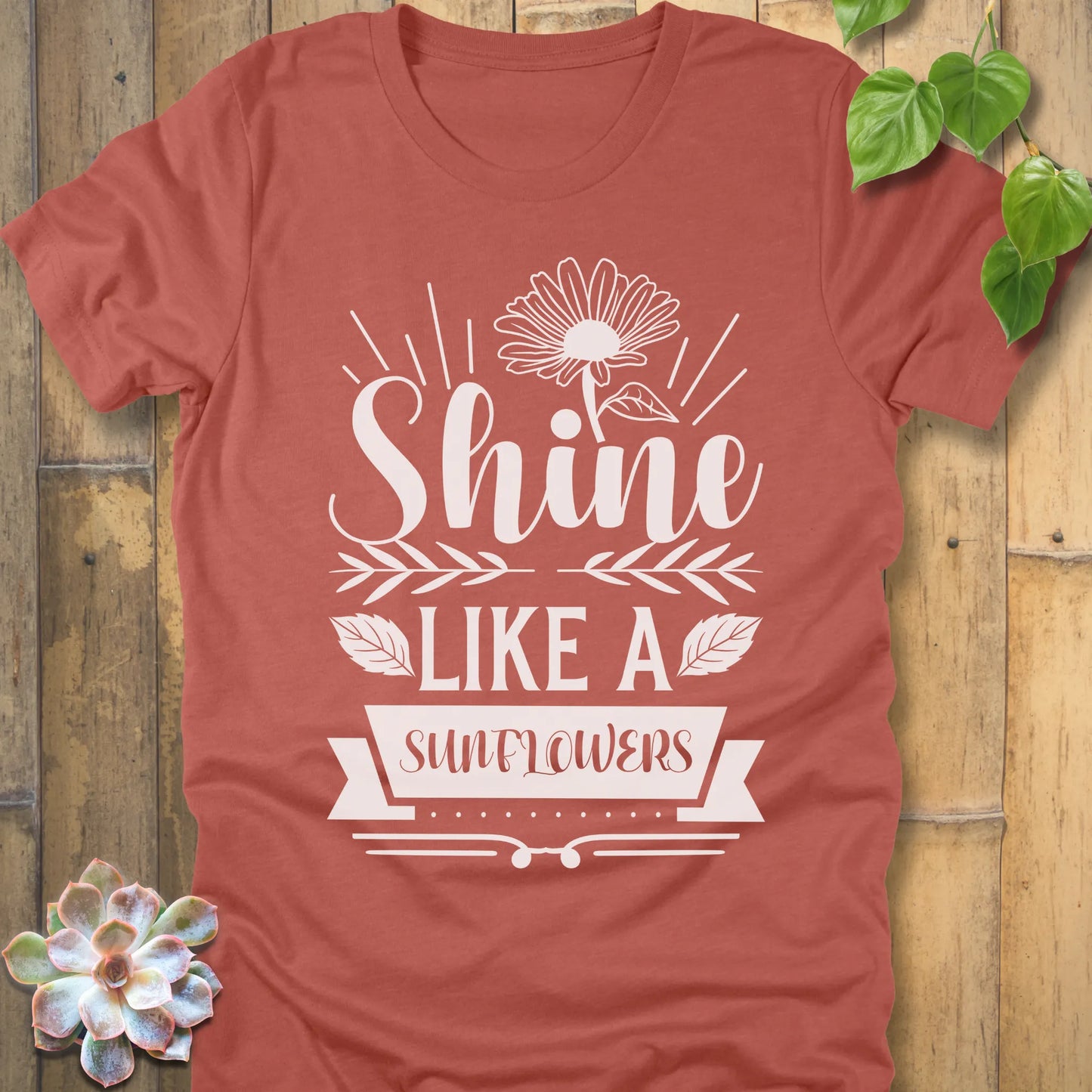 Heather Clay t-shirt featuring the design Shine Like A Sunflower printed in bold letters with sunflower