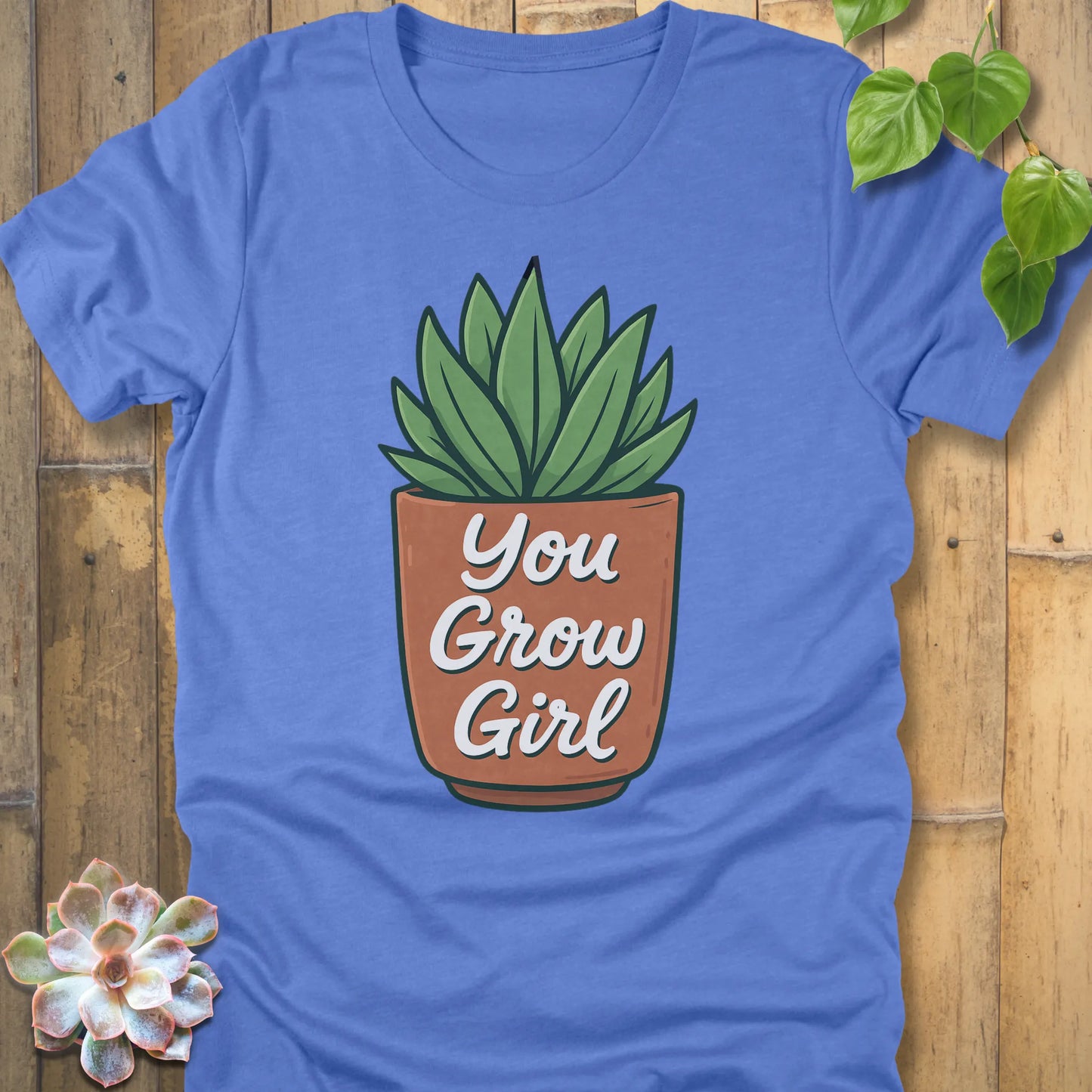 Heather Colombia Blue t-shirt featuring the design Grow Girl printed in bold letters and plant in the pot, casual plant lover shirt.