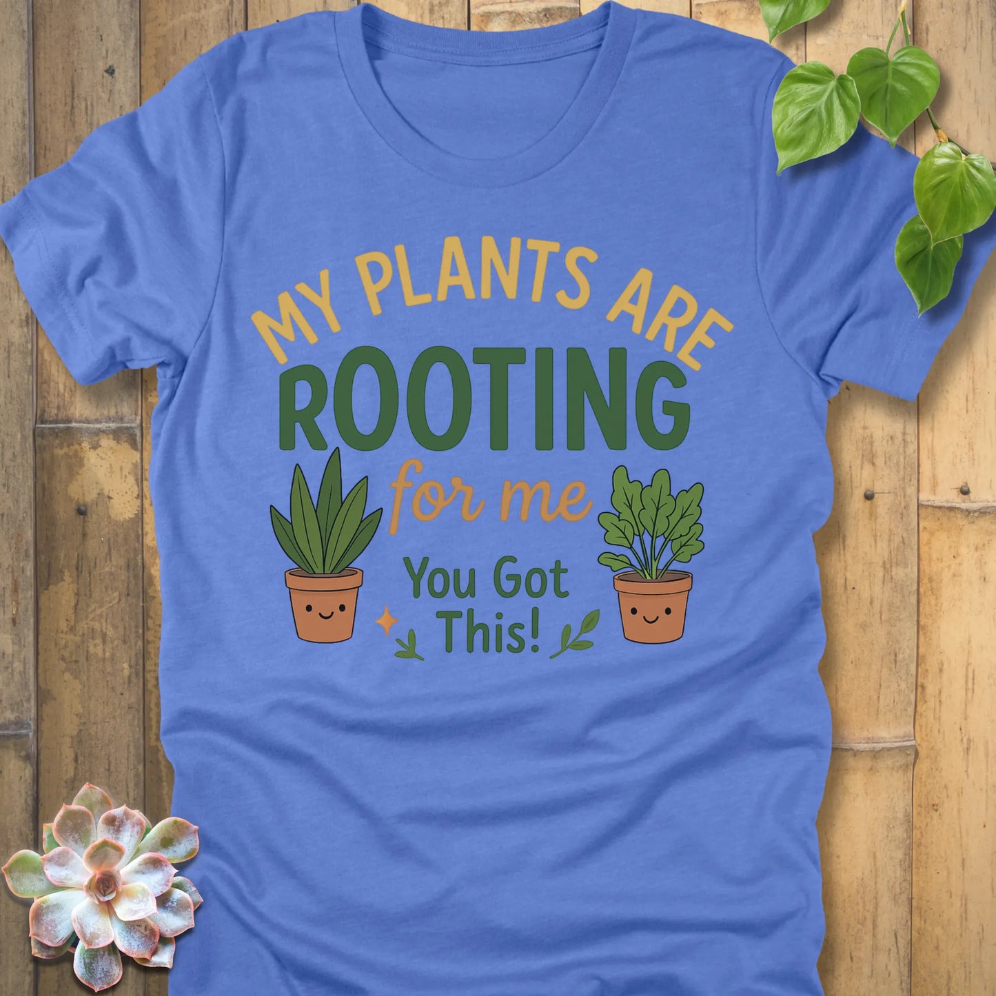 Heather Colombia Blue t-shirt featuring the design Rooting For Me printed in bold letters and plants, gardening graphic tee.