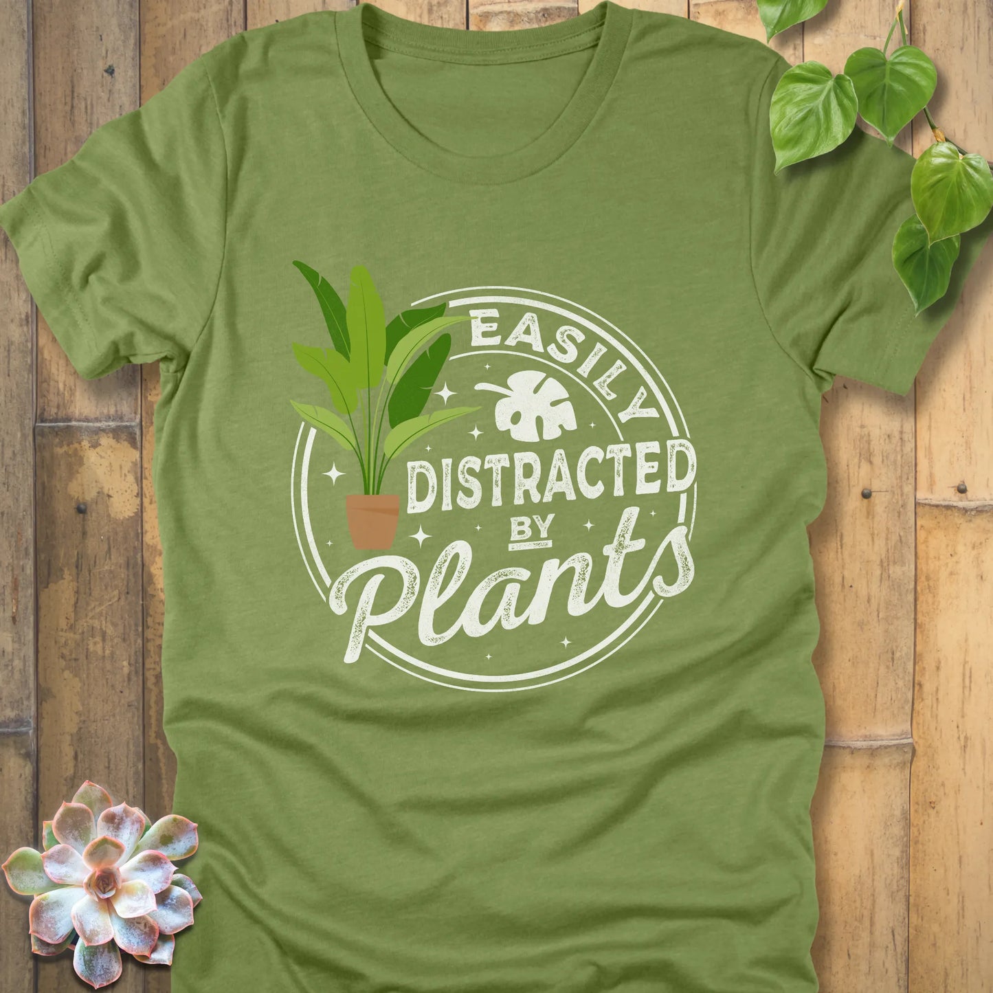 Heather Green t-shirt featuring the design Easily Distracted by Plants with a print of a potted plant