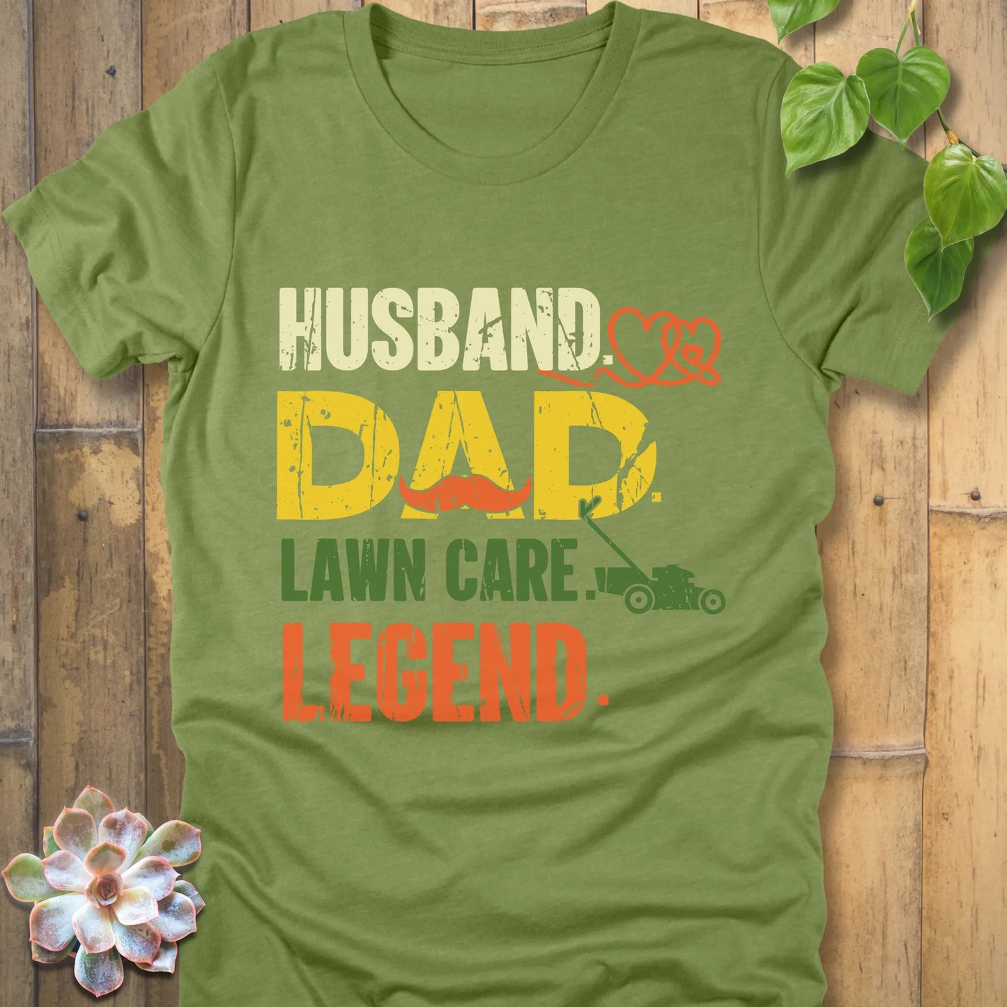 Heather Green t-shirt featuring the design "Husband, Dad lawn care legend" printed in bold letters