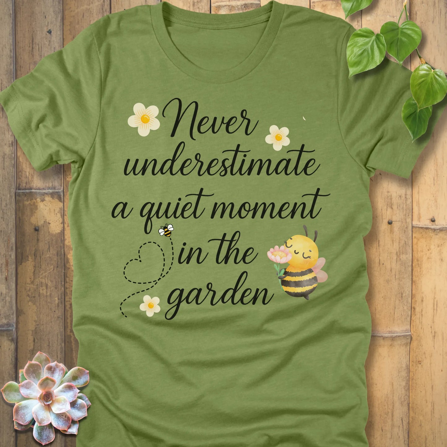 Heather Green t-shirt featuring the design Never Underestimate printed in black letters, empowering quote shirt.