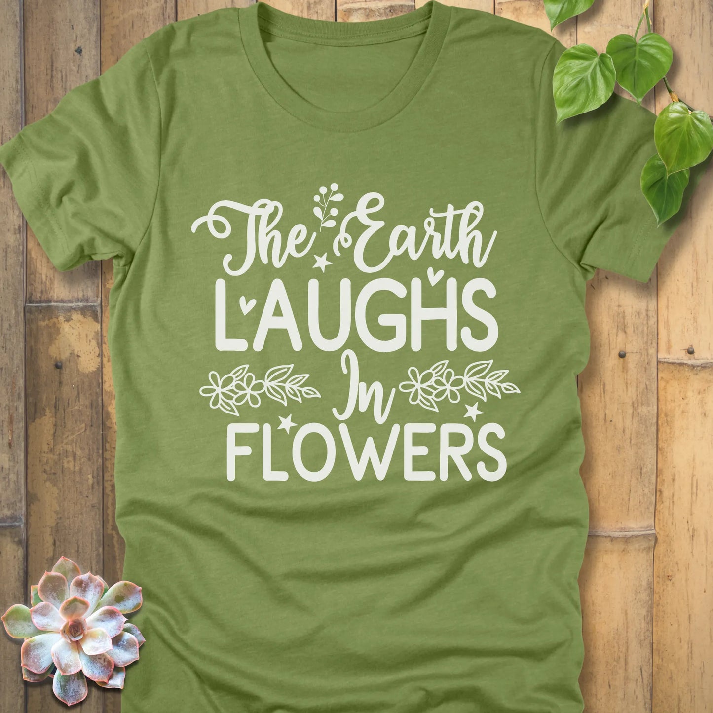 Heather Green t-shirt featuring the design The earth laughs in flowers printed in bold white letters