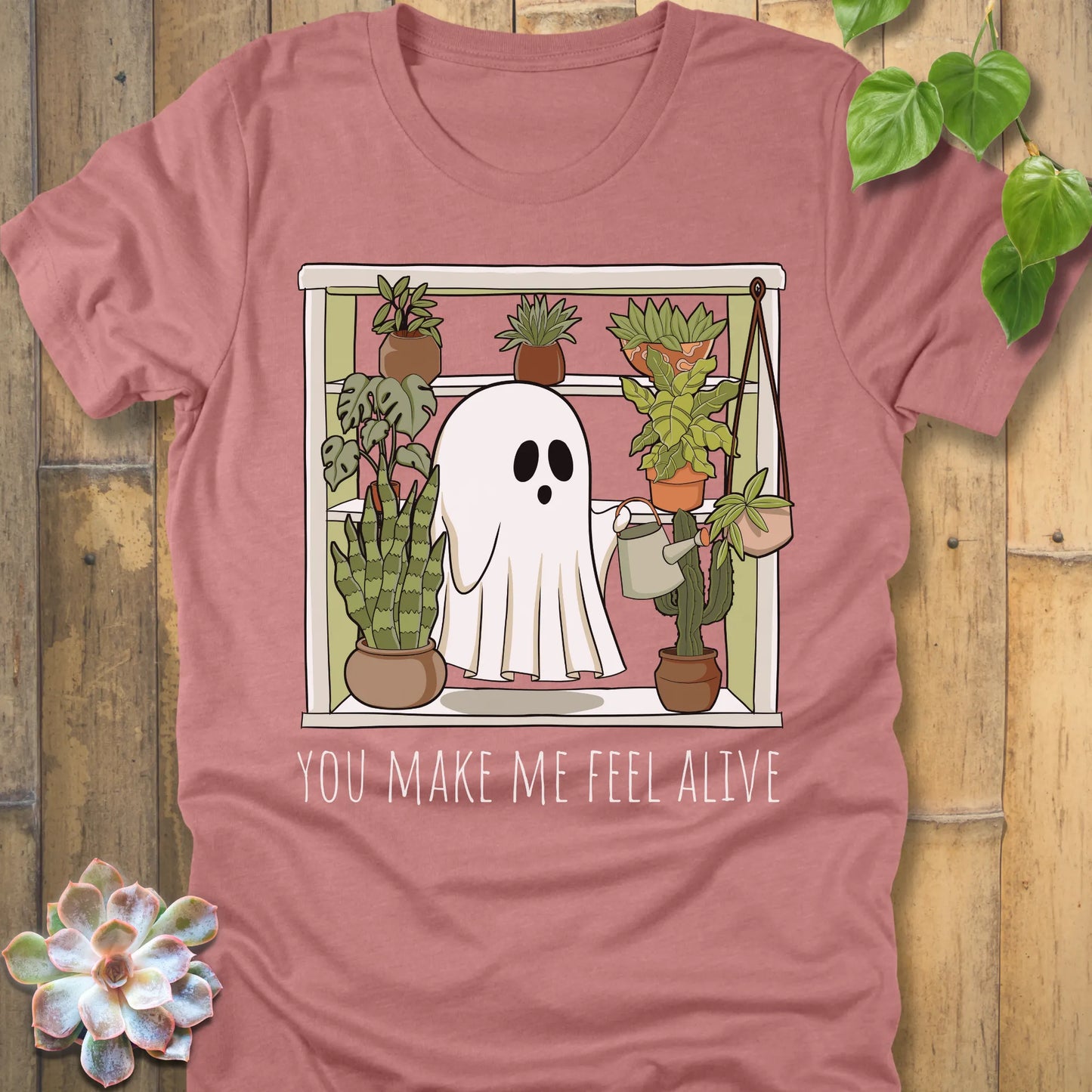 Heather Mauve t-shirt featuring the design Make Me Feel Alive printed in bold white letters and a halloween ghost watering the plants design