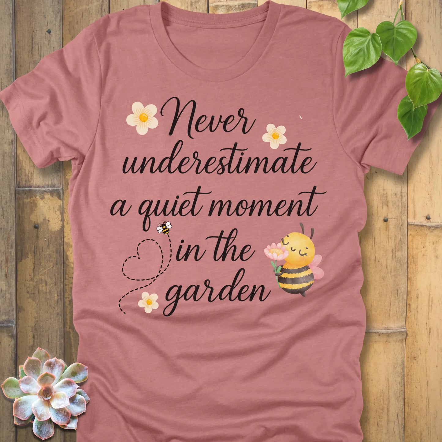 Heather Mauve t-shirt featuring the design Never Underestimate printed in black letters, empowering quote shirt.