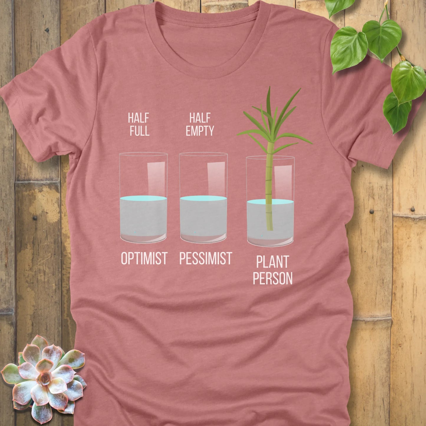 Heather Mauve t-shirt featuring the design Plant Person printed in bold letters printed in glass of water, and a plant