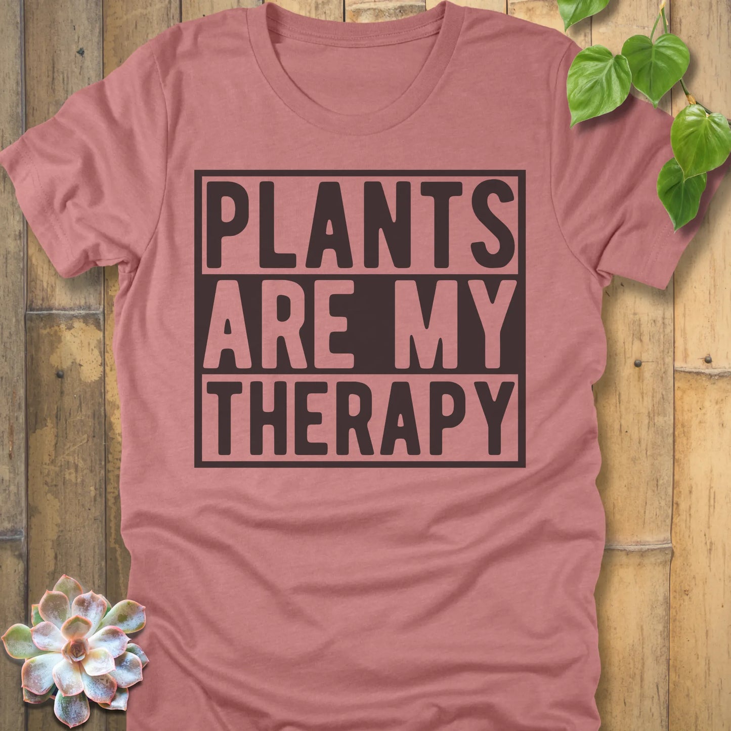 Heather Mauve t-shirt featuring the design Plants Are My Therapy printed in bold letters, plant lover shirt.