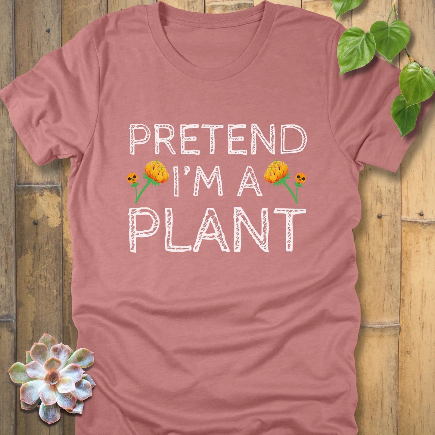 Heather Mauve t-shirt featuring the design Pretend I'm A Plant printed in white letters with plants