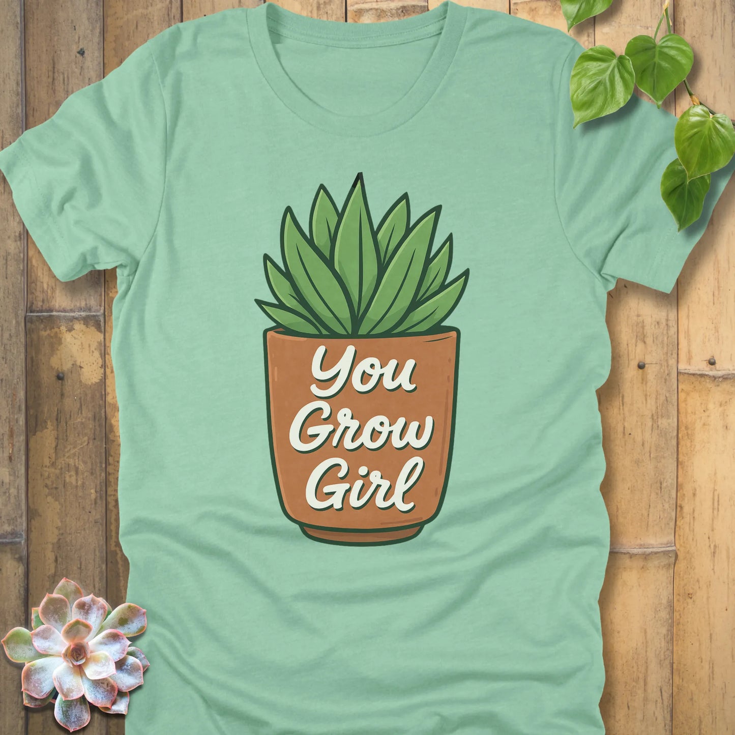 Heather Mint t-shirt featuring the design Grow Girl printed in bold letters and plant in the pot, casual plant lover shirt.