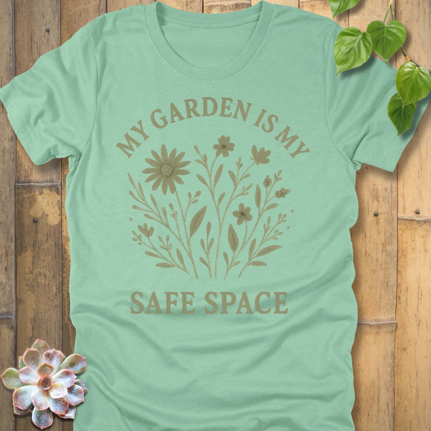 Heather Mint t-shirt featuring the design My Garden Is My Safe Place printed in bold letters, gardening shirt for plant lovers.