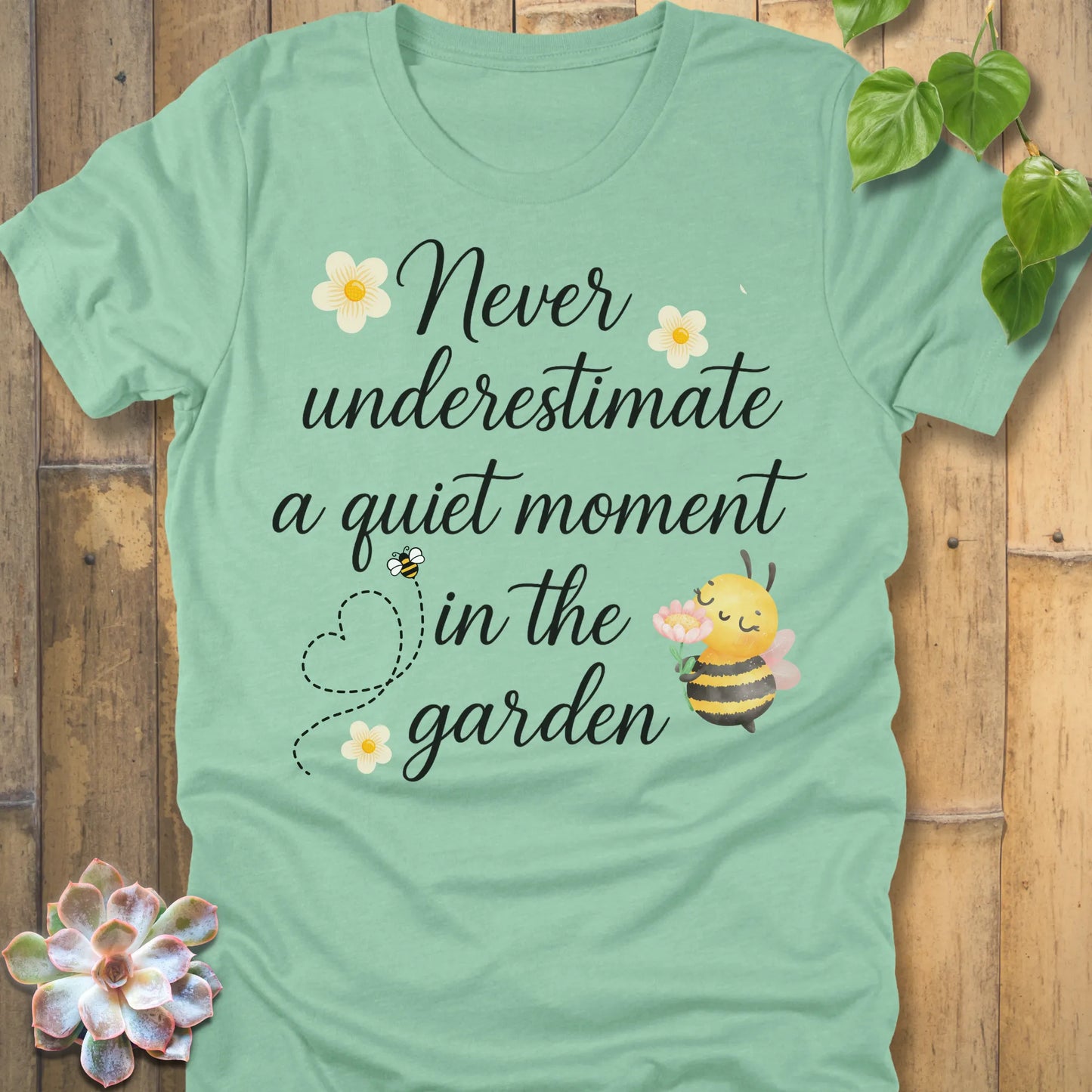 Heather Mint t-shirt featuring the design Never Underestimate printed in black letters, empowering quote shirt.