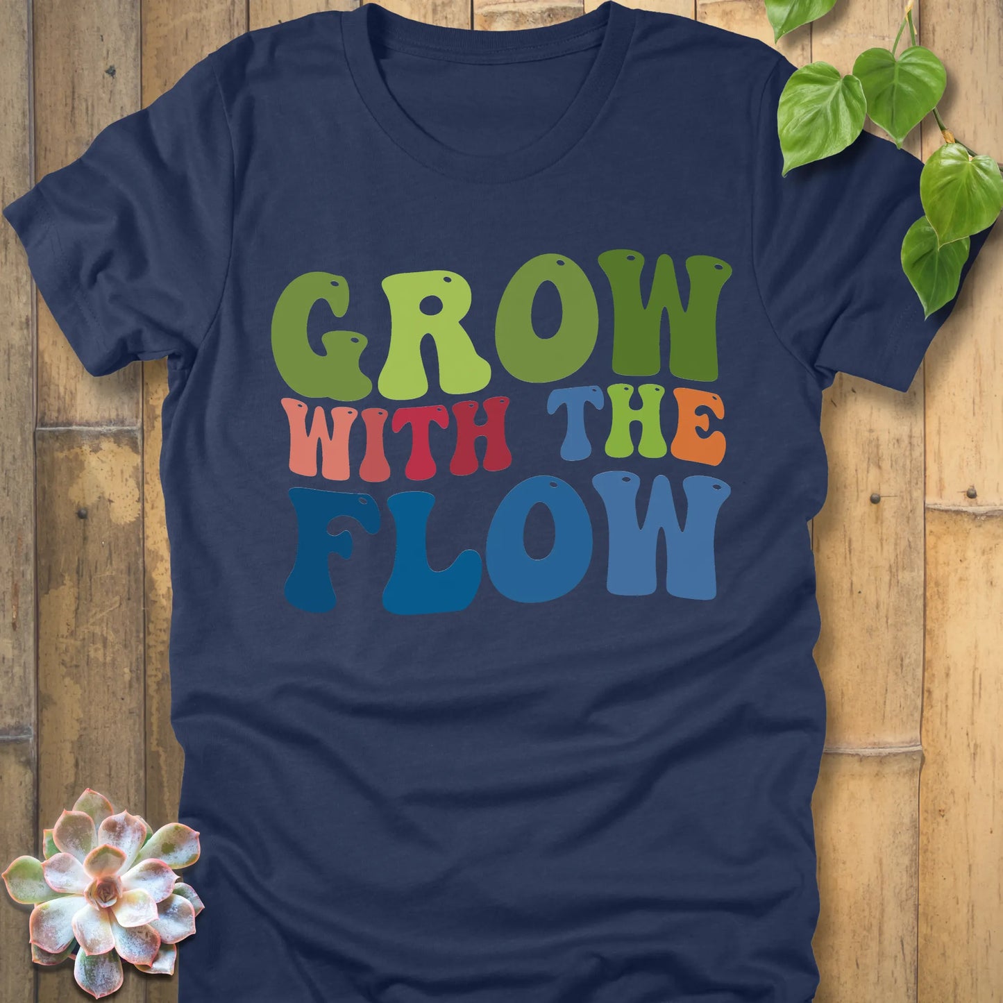 Heather Navy t-shirt featuring the design Grow In The Flow printed in colourful bold letters