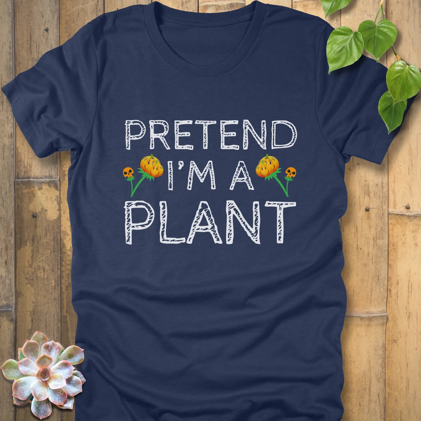 Heather Navy t-shirt featuring the design Pretend I'm A Plant printed in bold white letters with plants