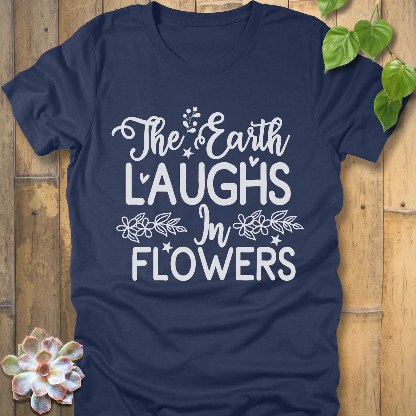 Heather Navy t-shirt featuring the design The earth laughs in flowers printed in bold white letters