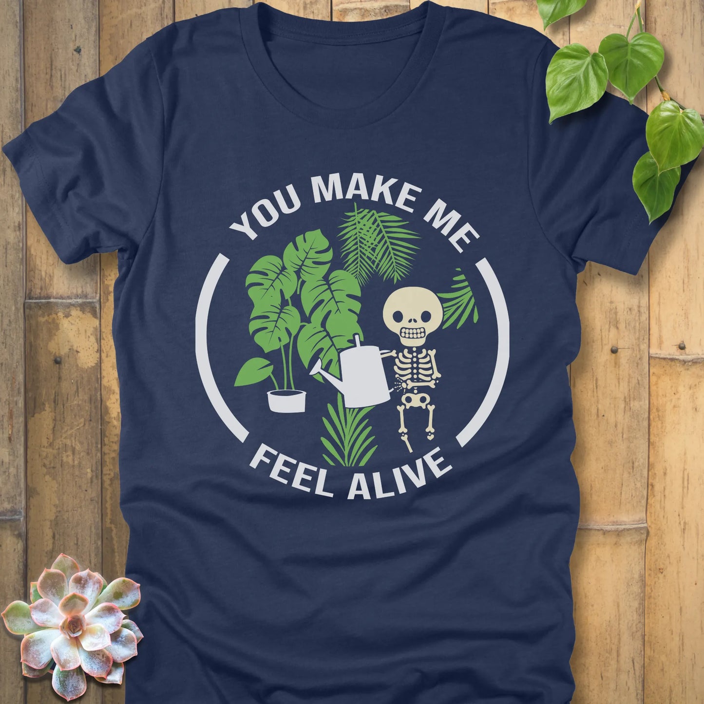 Heather Navy t-shirt featuring the design You make me feel alive with plant and skeleton in bold white letters