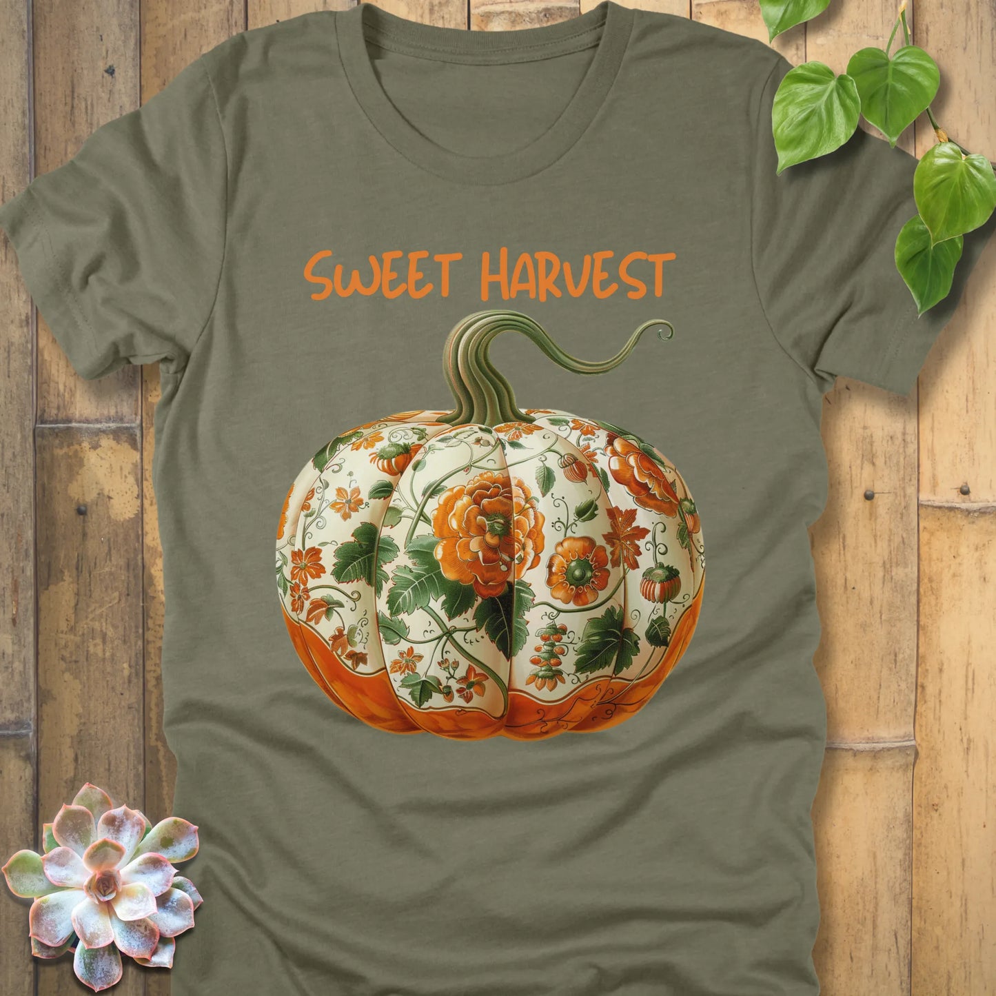 Heather Olive t-shirt featuring the design Sweet Harvest printed in bold orange letters and a halloween pumpkin design