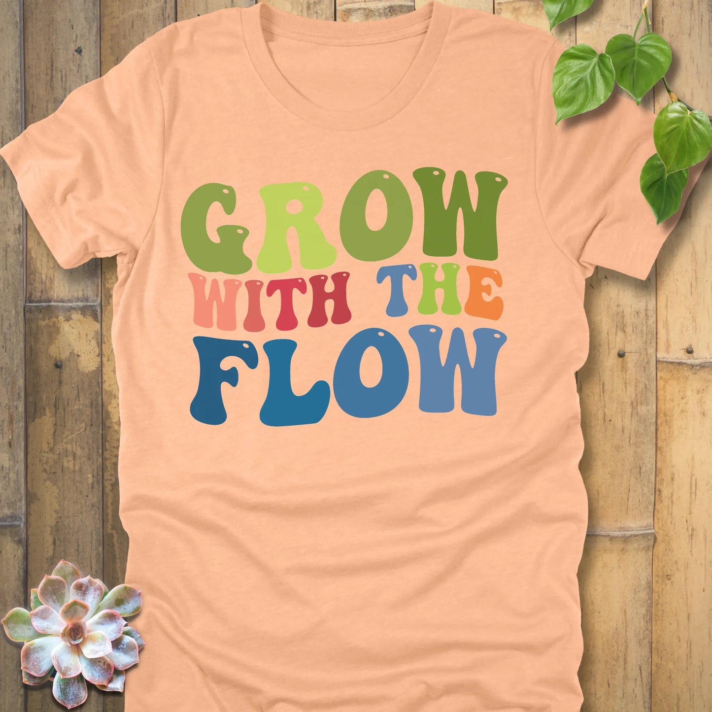 Heather Peach t-shirt featuring the design Grow In The Flow printed in colourful bold letters