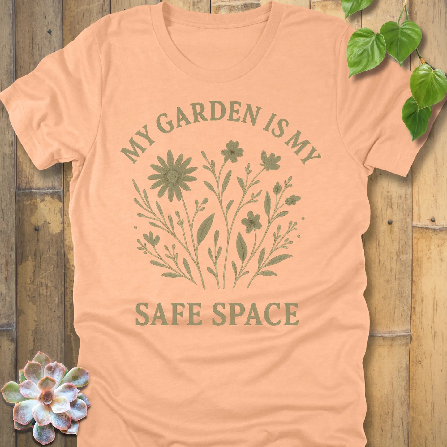 Heather Peach t-shirt featuring the design My Garden Is My Safe Place printed in bold letters, gardening shirt for plant lovers.