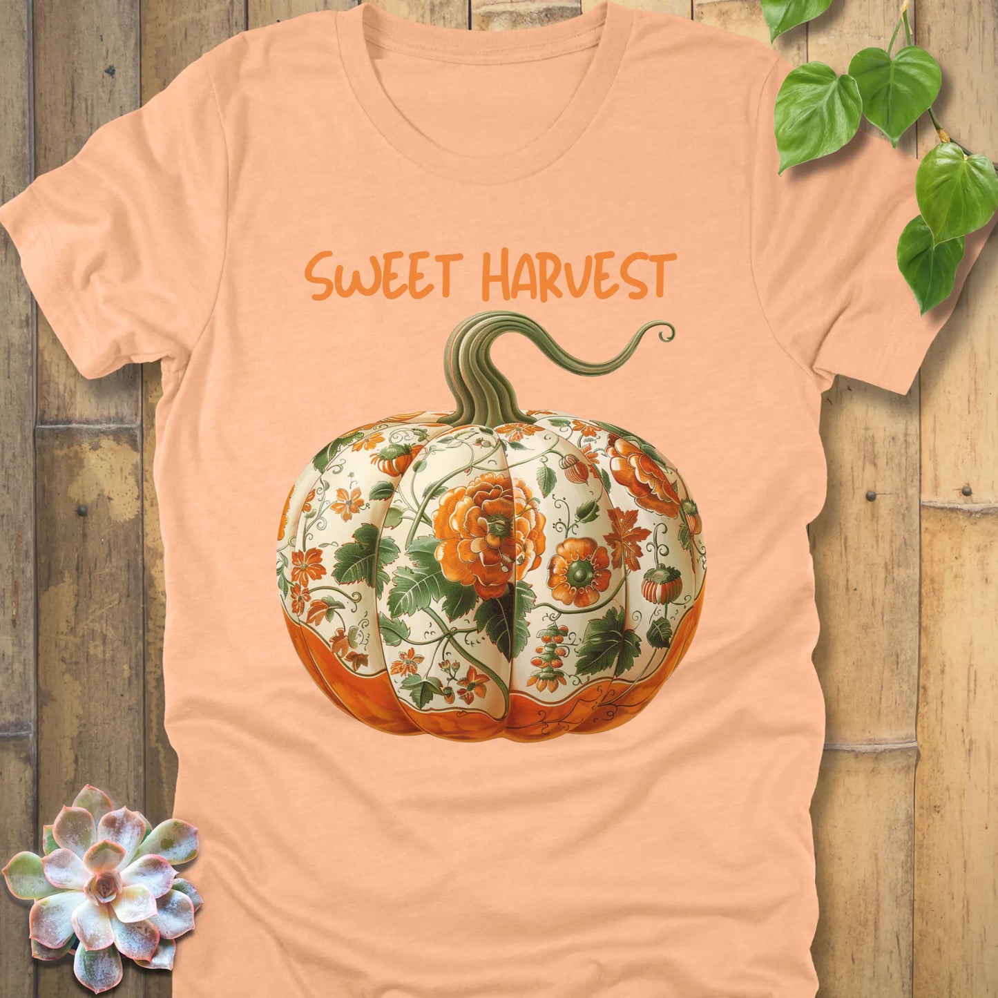 Heather Peach t-shirt featuring the design Sweet Harvest printed in bold orange letters and a halloween pumpkin design