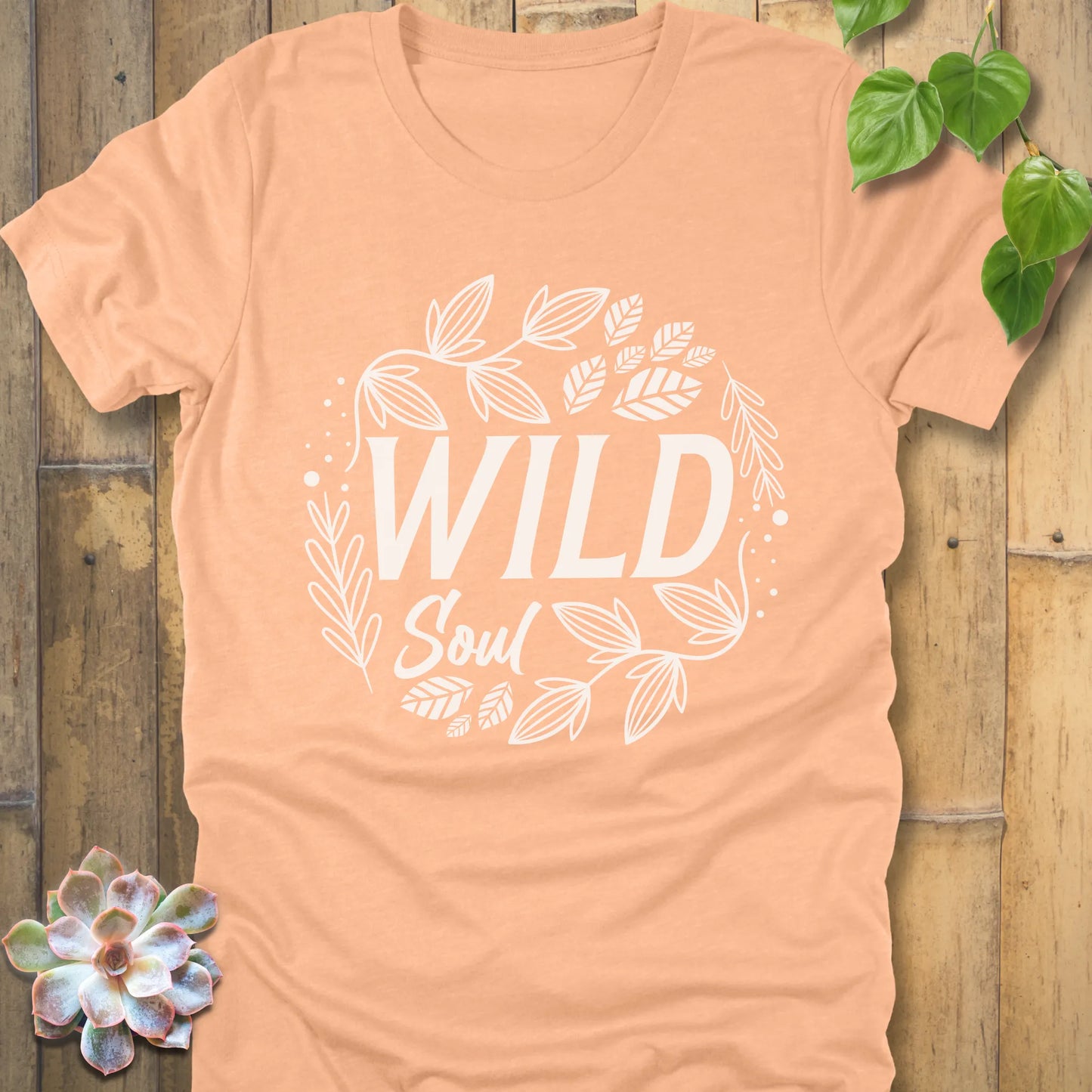Heather Peach t-shirt featuring the design Wild Soul printed in black letters with leaves