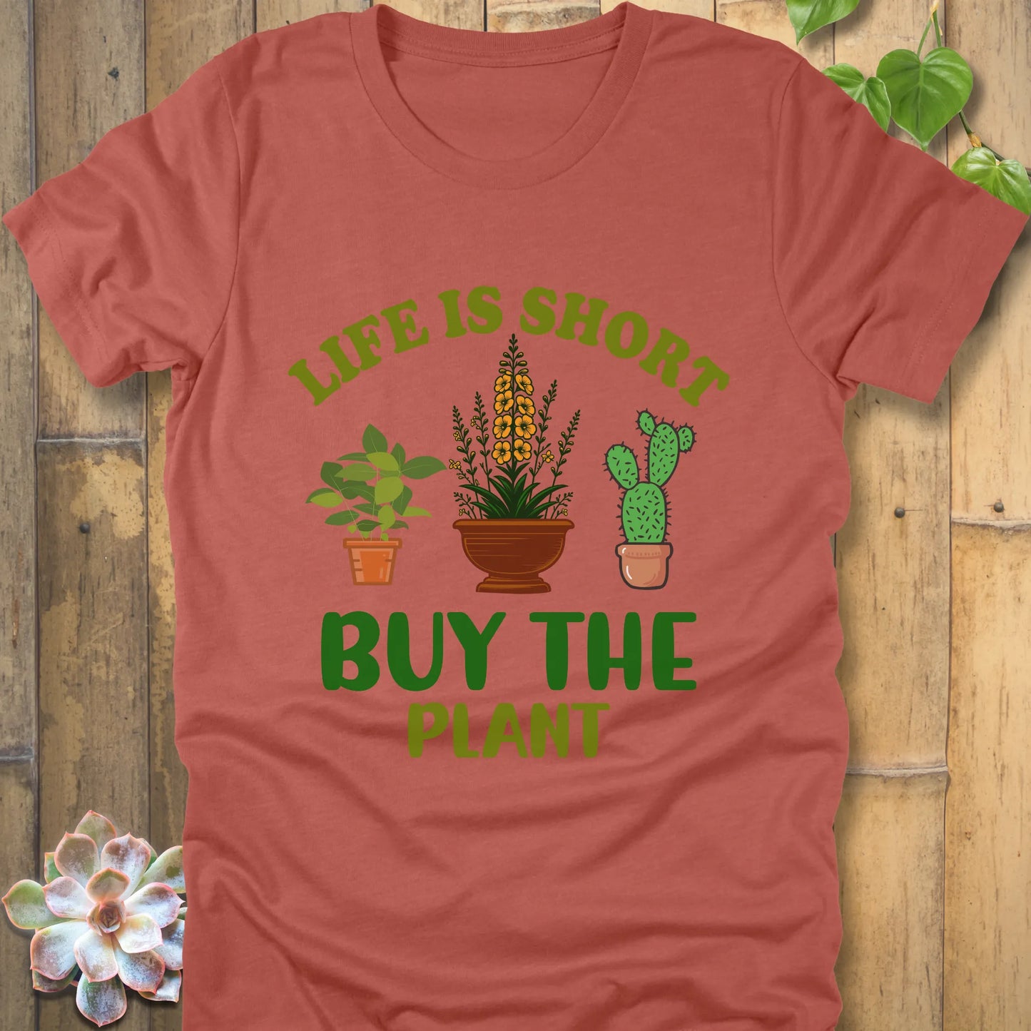 Heather clay t-shirt featuring the design Life is short, buy the plant printed in green text with plant illustration
