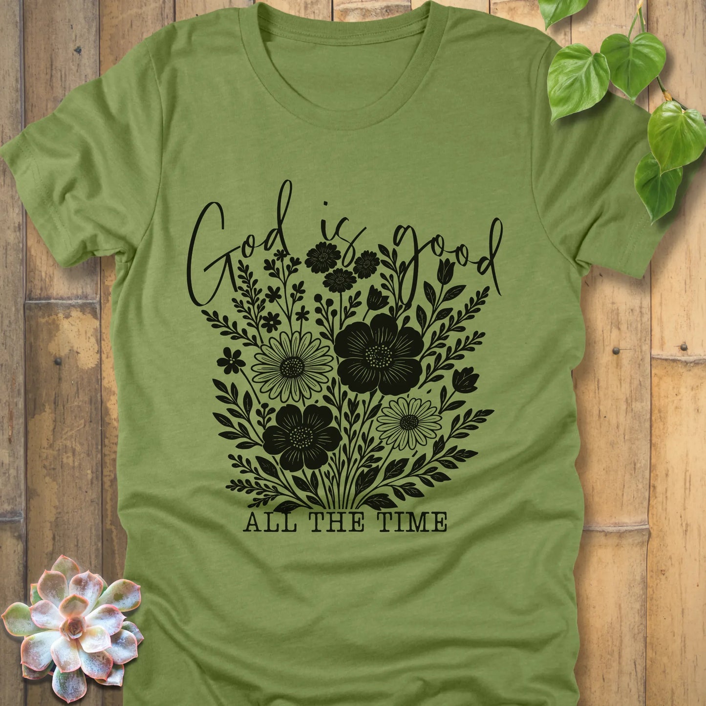 Heather green t-shirt featuring the design God is Good printed with flowers in a soft floral style