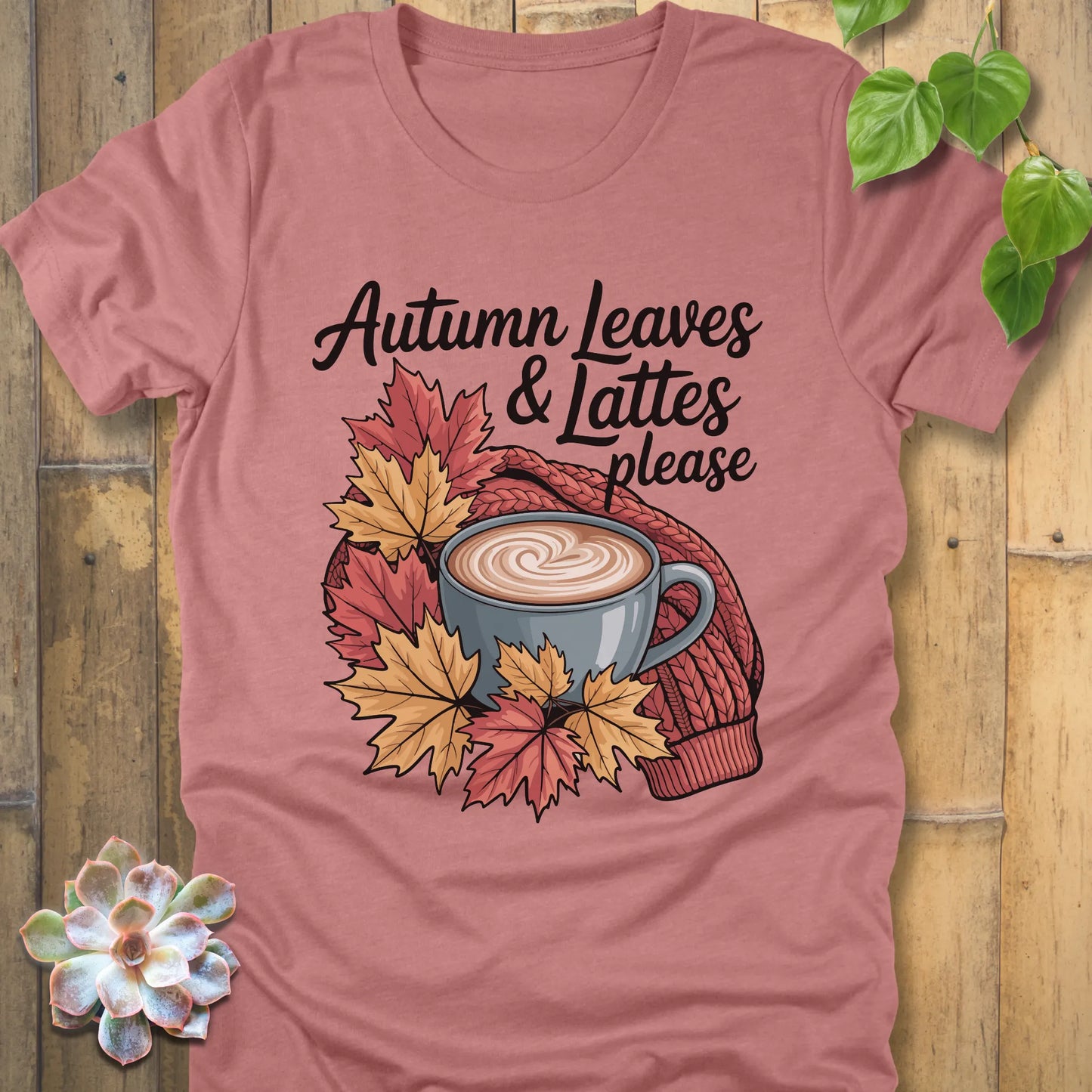 Heather mauve t-shirt featuring the design Autumn Leaves & Lattes printed in black letters with a mug of coffee and leaves