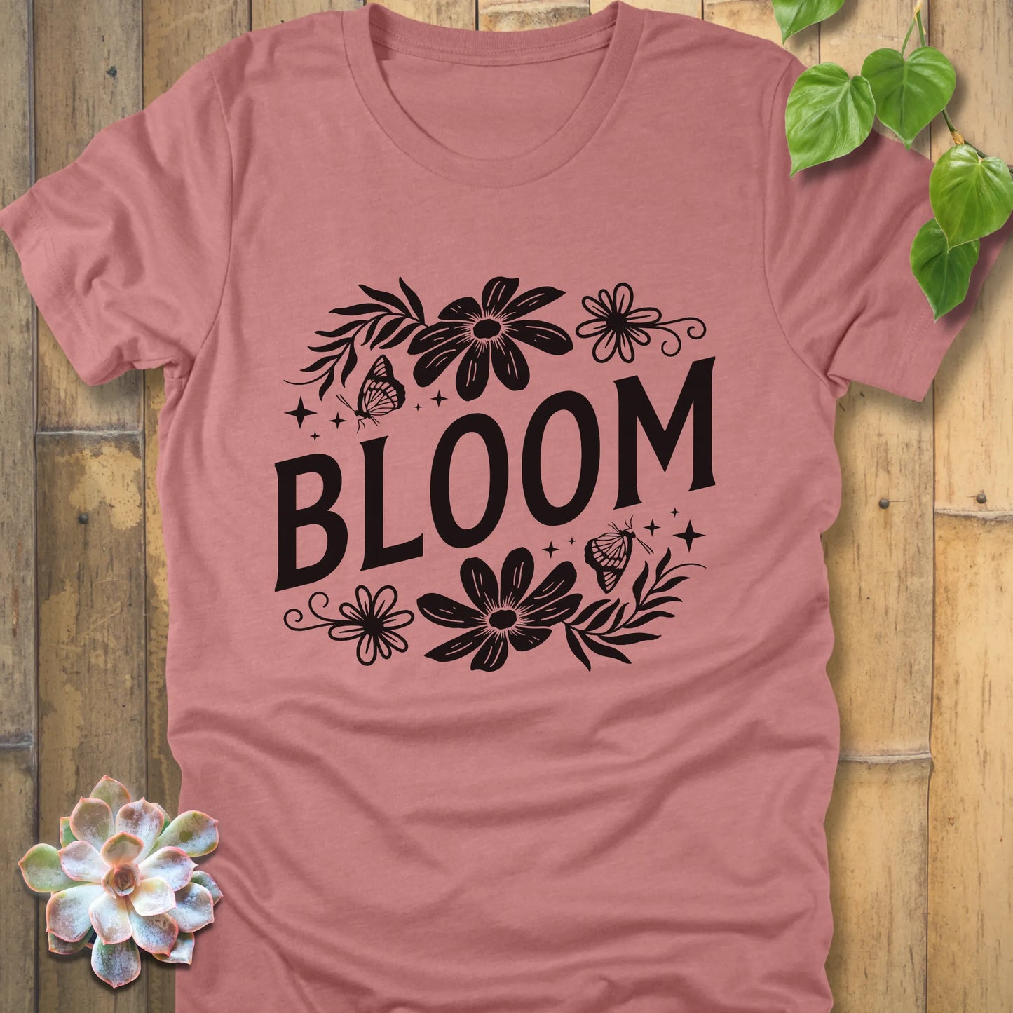 Heather mauve t-shirt featuring the design " Bloom " printed in bold black letters with flowers